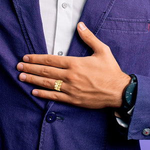 Man in a blue blazer wearing a gold nugget ring