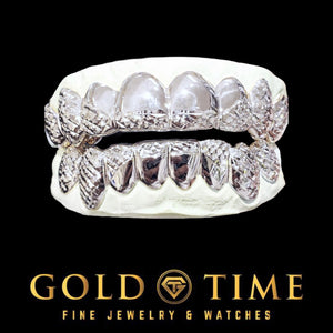 Silver 16 piece trillion cut grillz set on top and bottom dental models