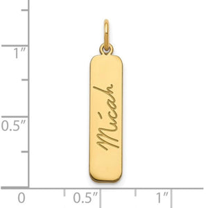 Yellow gold handwriting bar pendant next to a ruler showing it is just over 1 inch tall