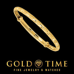 14k yellow gold star-cut baby bangle with a diamond-cut star pattern