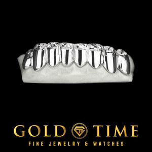 Bottom 8 piece solid silver grill with perm cut lines and diamond dust tips on a dental mold
