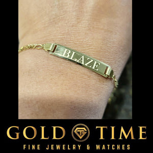 Child's wrist wearing a gold ID bracelet engraved with the name Blaze