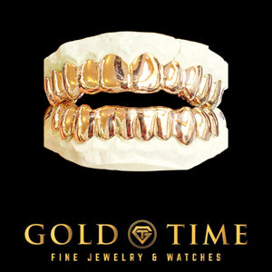 Solid rose gold top and bottom grillz with perm cut detailing on dental molds
