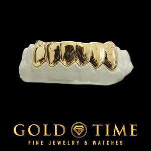 Yellow gold 6 piece solid perm cut grillz on a dental mold