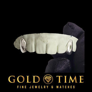 White metal 2 piece solid canine fang caps on a dental model held in a gloved hand, Gold Time