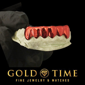 Custom 6 piece red plated solid grillz held on a dental mold