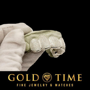 Angled view of the frosted diamond dust grillz held in a gloved hand