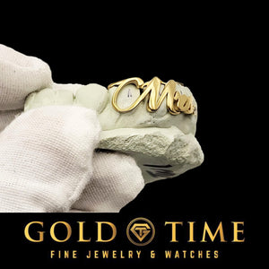 Gold 'Mrs." grillz held by a gloved hand, Gold Time jewelry brand visible