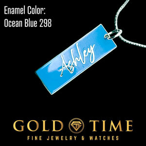 Close up of a sterling silver name charm with Ocean Blue 298 enamel and script name Ashley