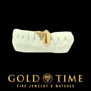 Yellow gold diagonal cut incisor cap grill on a bottom dental mold