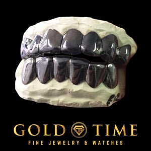 Black gold solid perm cut grillz, top and bottom, on dental molds