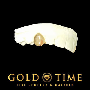 Solid yellow gold single tooth cap on a dental mold, Gold Time