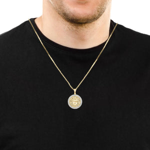 Man wearing a 10K gold Medusa diamond pendant on a chain
