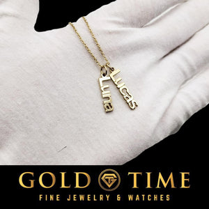 Gold two name vertical charm necklace draped over a gloved hand