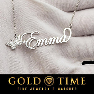Close-up of a silver butterfly nameplate reading Emma, showing the butterfly wing detail