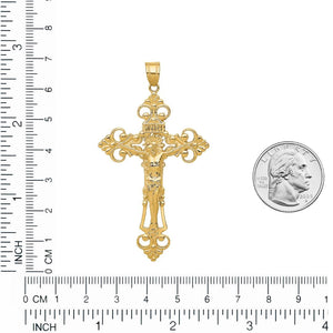Gold INRI fleur de lis crucifix pendant measured against a ruler next to a quarter, about two and a half inches tall