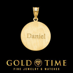 Satin-finish back of a gold baseball pendant engraved with the name Daniel