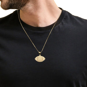 Man wearing a small gold football jersey number pendant on a fine chain