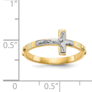 Two-tone crucifix ring next to a ruler for scale