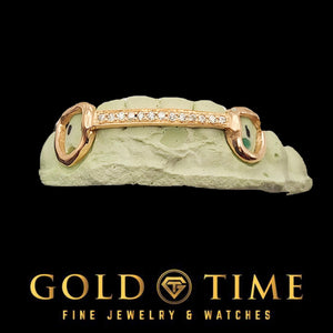 Rose gold open face grillz with a moissanite center row and a green stone accent