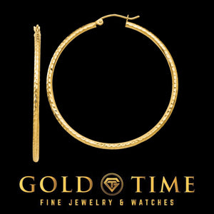 Large yellow gold diamond cut hoop earring shown with its pair on edge
