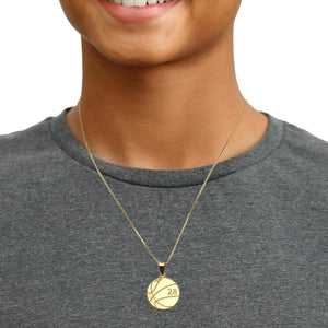 Young man wearing a yellow gold basketball number pendant on a chain
