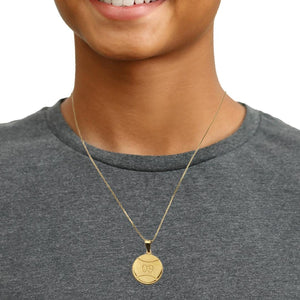 Person wearing a small gold engraved baseball number pendant on a fine gold chain