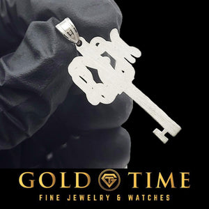 Close view of the script monogram key pendant showing the cut out lettering