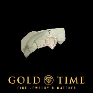 Yellow gold double cap grill with a stone set open face fang and incisor tip on a mold