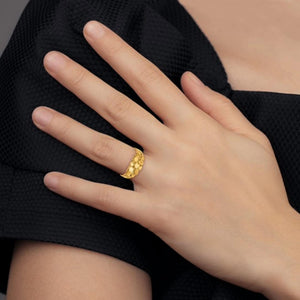 Gold nugget ring worn on hand