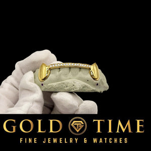 Custom yellow gold fang grillz with moissanite tip bar on a mold