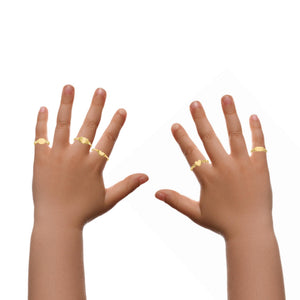 Two small hands wearing 14k gold children's signet rings to show the scale