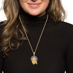 Woman wearing a tri-color gold Jesus pendant on a gold chain