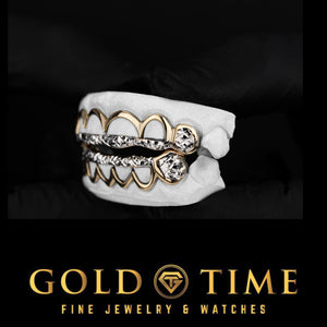 Left angle of the 12 piece two-tone grillz showing yellow gold window frames and white diamond-cut tip bars on top and bottom