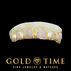 6 piece top grill with white diamond dust faces inside yellow gold frames on a dental mold