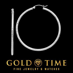Large white gold diamond cut hoop earring shown with its pair on edge