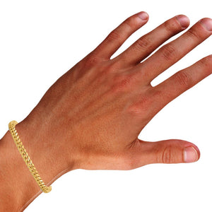 Hand wearing a yellow gold 5.5mm Miami Cuban bracelet