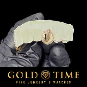 Single tooth open face grillz cap in yellow gold with a handset moissanite border, shown on a dental mold