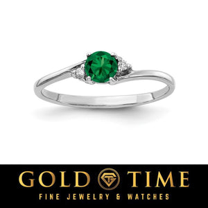 14k white gold bypass ring with a round deep green gemstone and diamond accents