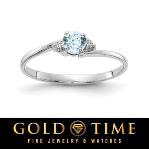 14k white gold bypass ring with a round pale blue gemstone and diamond accents