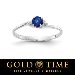 14k white gold bypass ring with a round deep blue sapphire and diamond accents