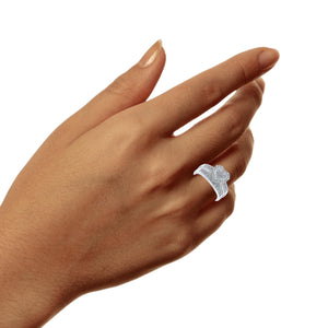 Sterling silver heart diamond bridal set worn on a hand, showing the halo top and split shank band