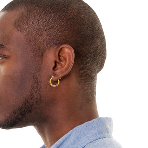 Man wearing a small gold diamond cut hoop earring, shown in profile