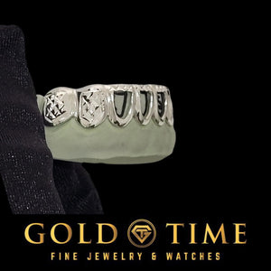 Angled view of the eight piece open face grillz showing the box edges and open centers