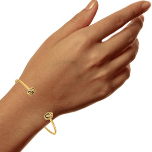 Woman wearing a 14k gold love knot stud earring