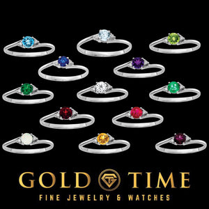 Twelve 14k white gold gemstone rings in different stone colors arranged on a black background