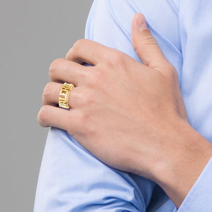 Man wearing a yellow gold personalized name ring on his ring finger