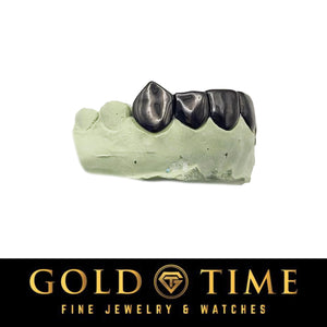 Black rhodium six piece fang grillz on a cream dental model, side view showing the pointed canines