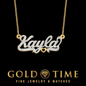 Two tone 3D name necklace reading Kayla, diamond covered white gold script over yellow gold with a small heart