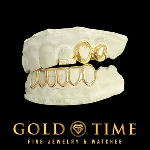 Custom 3 piece heart cut-out grillz on top teeth with an open face bottom set